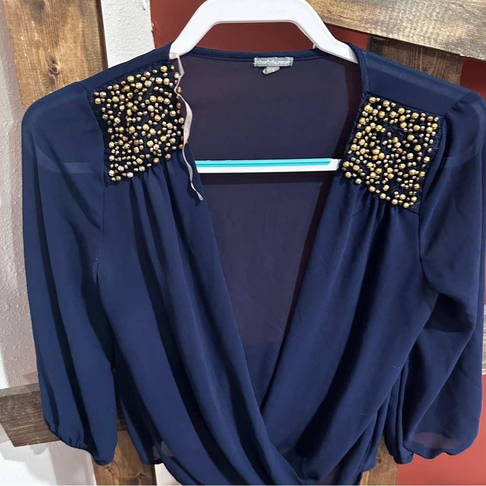 Blue top with gold beaded shoulders. Size small